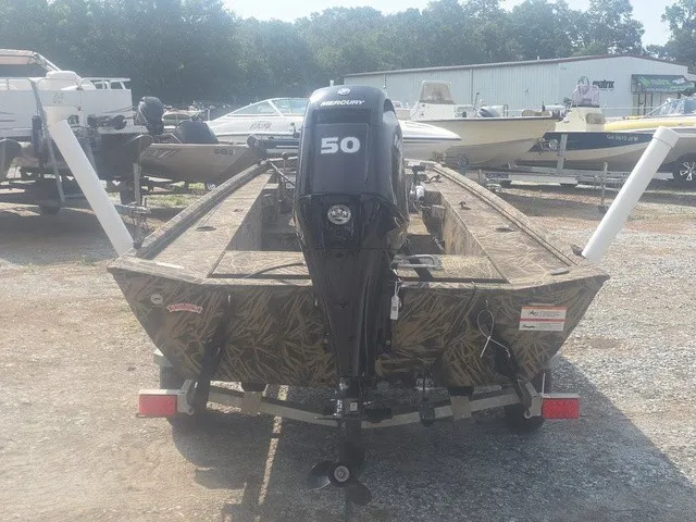 Slide: The Image of A 2022 Lowe Skorpion SS boat with a 50 HP motor, parked on a trailer. - 7
