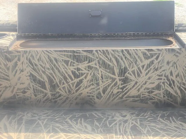 Slide: The Image of A boat with a camouflage pattern and an open storage compartment. - 21