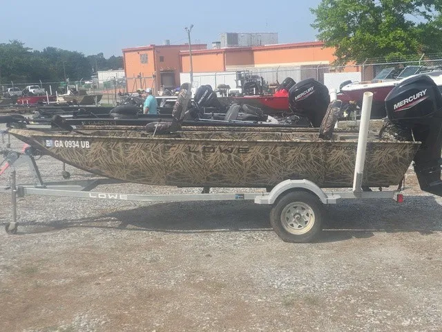 Slide: The Image of A 2022 Lowe Skorpion SS boat on a trailer, featuring a Mercury outboard motor. - 9
