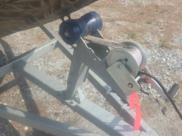 Slide: The Image of Close-up of a boat trailer winch with a cable and blue roller. - 27