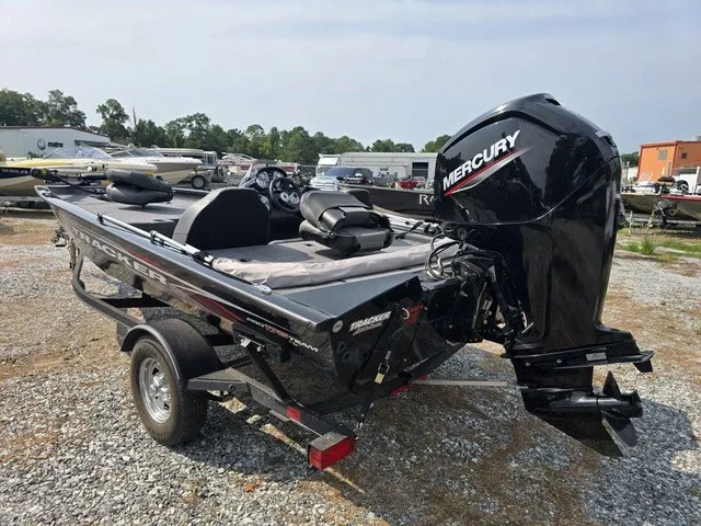 Slide: The Image of A black 2020 Tracker Pro Team 175 TXW boat on a trailer, featuring a Mercury outboard motor. - 13