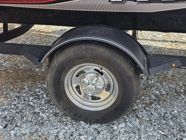 Slide: The Image of Close-up of a boat trailer wheel on gravel ground. - 6