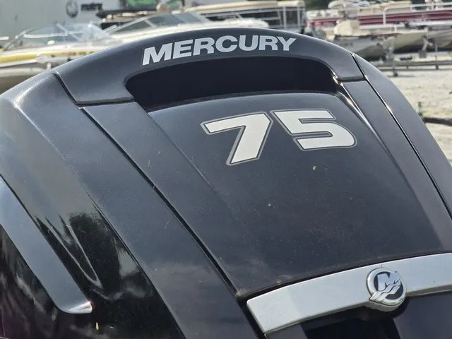 Slide: The Image of Outboard motor labeled "Mercury 75" on a boat. - 11