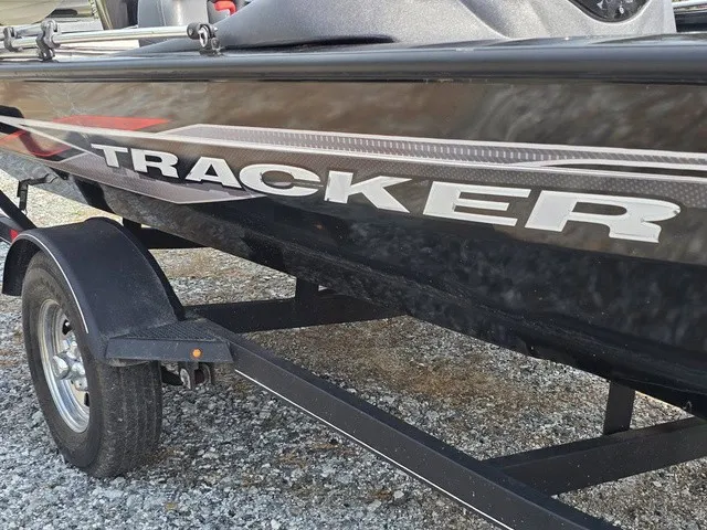 Slide: The Image of A black boat with "TRACKER" on the side is on a trailer. - 5