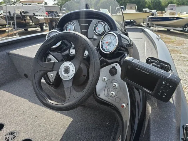 Slide: The Image of The image shows the cockpit of a 2020 Tracker Pro Team 175 TXW boat with a modern helm and instruments. - 26
