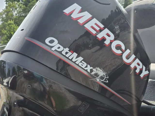 Slide: The Image of Close-up of a Mercury OptiMax outboard motor mounted on a boat. - 7