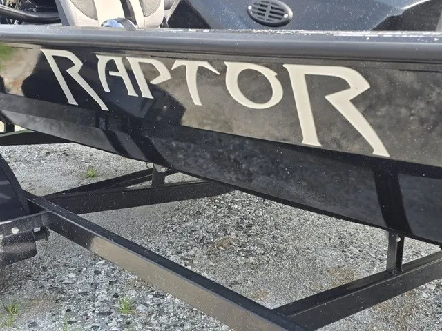 Slide: The Image of Close-up of the black Caravelle RAPTOR boat with bold lettering on the side. - 4