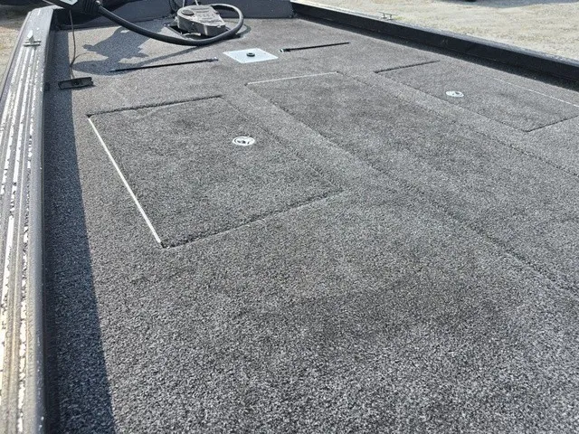 Slide: The Image of The image shows the gray deck of a 2020 Caravelle RAPTOR boat with storage hatches. - 18