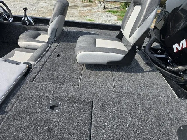 Slide: The Image of The image shows the interior of a 2020 Caravelle RAPTOR boat with gray seats and carpeted flooring. - 14