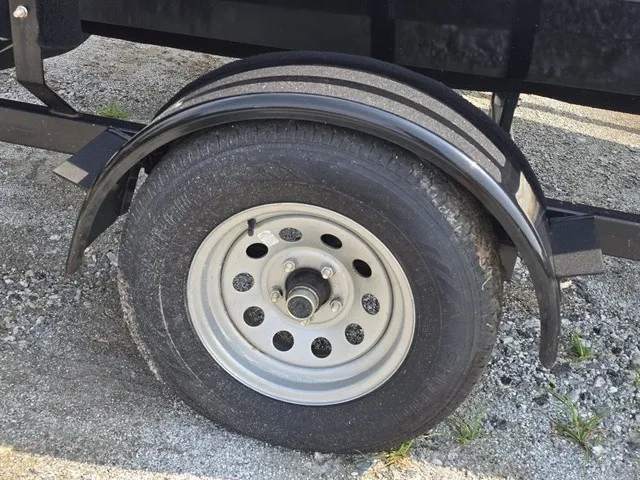 Slide: The Image of Close-up of a boat trailer wheel on gravel ground. - 5