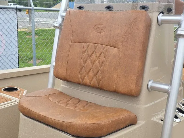 Slide: The Image of Brown cushioned seat on a boat with quilted pattern and metal frame. - 11