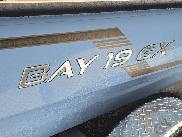 Slide: The Image of Close-up of "Bay 19 GX" lettering on a blue boat hull. - 13