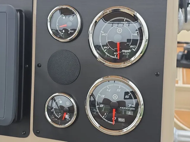 Slide: The Image of Close-up of four round gauges on a boat panel, including a speedometer and tachometer. - 23