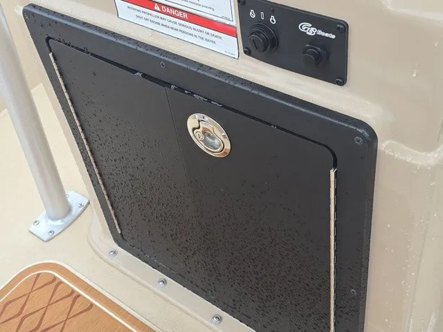 Slide: The Image of Close-up of a black storage compartment with a round handle on a G3 Bay 19 GX boat. - 26