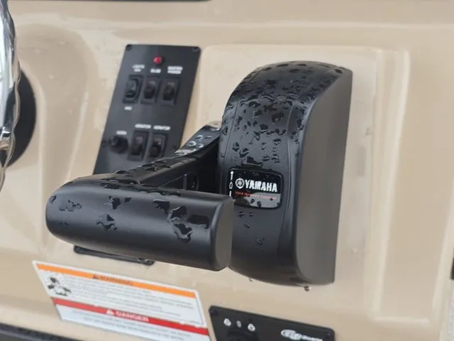 Slide: The Image of Close-up of a Yamaha throttle lever on a G3 Bay 19 GX boat, surrounded by controls. - 22
