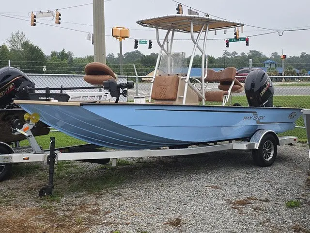Slide: The Image of A 2026 G3 Bay 19 GX boat on a trailer, featuring a blue hull and two outboard motors. - 4