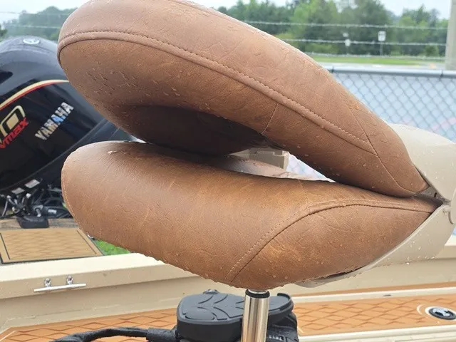 Slide: The Image of Close-up of a brown boat seat with a Yamaha motor in the background. - 7