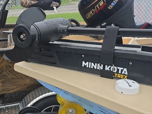 Slide: The Image of Close-up of a Minn Kota trolling motor on a boat, with a Yamaha motor in the background. - 5