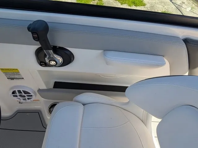 Slide: The Image of Interior view of a Chaparral 21 SSi boat with white seating and a control lever. - 27