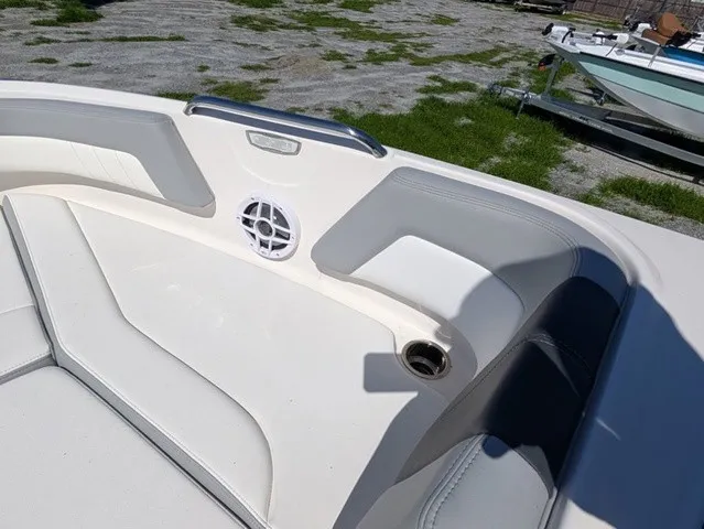 Slide: The Image of The image shows the bow area of a Chaparral 21 SSi boat with white and gray upholstery. - 18
