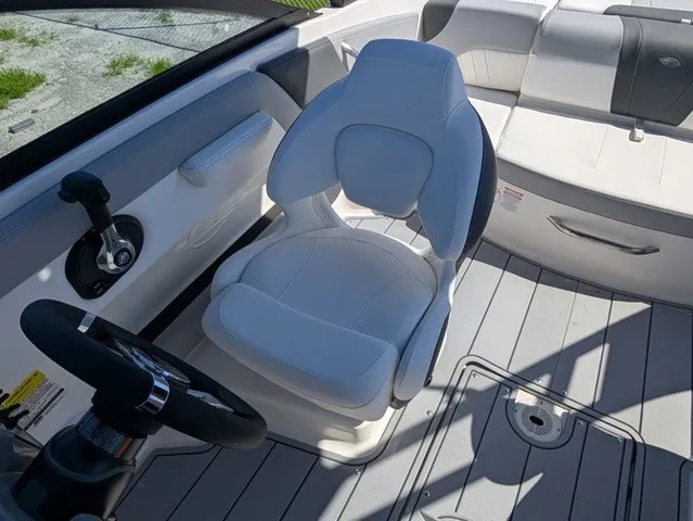 Slide: The Image of Interior view of a Chaparral 21 SSi with white seating and gray flooring. - 21
