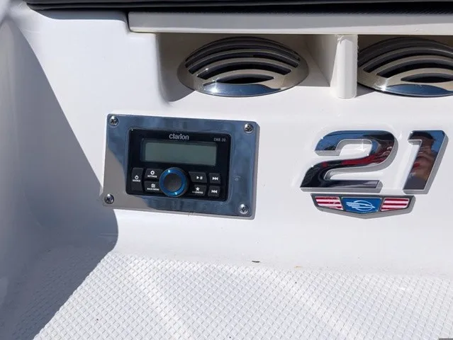 Slide: The Image of Close-up of a Clarion audio system and "21" emblem on a Chaparral boat. - 35