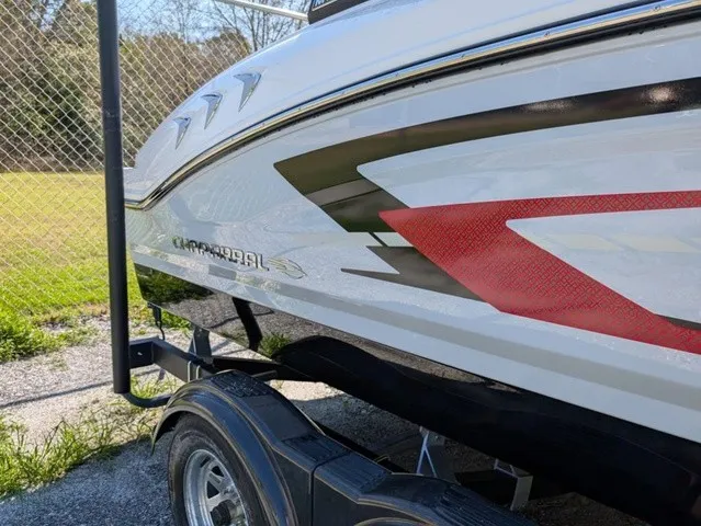 Slide: The Image of The image shows the side of a Chaparral 21 SSi boat on a trailer. - 7