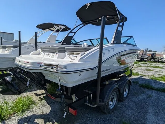 Slide: The Image of A 2026 Chaparral 21 SSi boat on a trailer, featuring a black bimini top and sleek white body. - 12