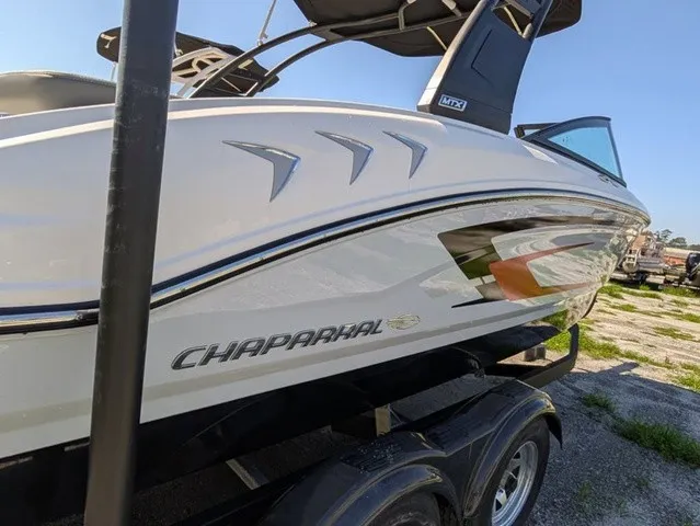 Slide: The Image of Chaparral 21 SSi 2026: Sleek design, white hull, parked on a trailer outdoors. - 14