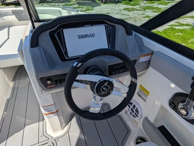 Slide: The Image of The image shows the helm of a Chaparral 21 SSi boat with a modern Simrad display. - 29