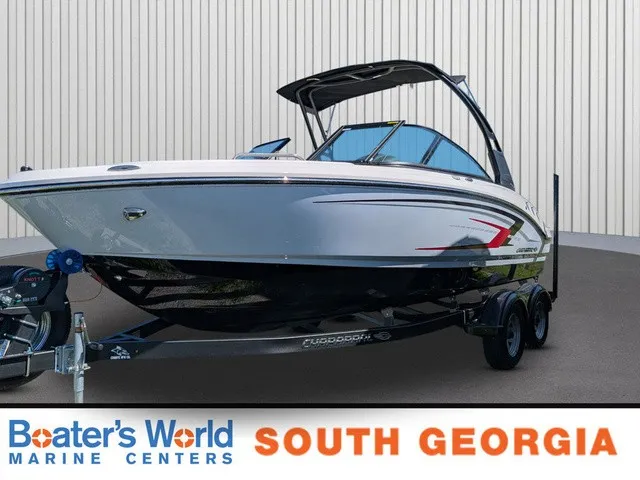 The Image of A 2026 Chaparral 21 SSi boat on a trailer in front of a building. - 1