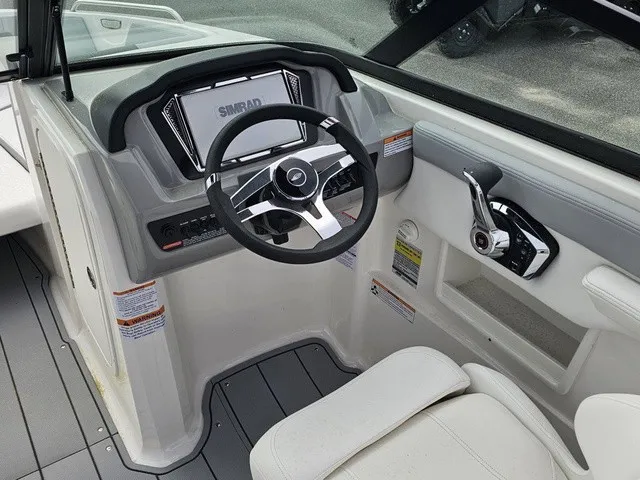 Slide: The Image of The image shows the cockpit of a Chaparral 23 SSi boat with a modern steering wheel and Simrad display. - 21