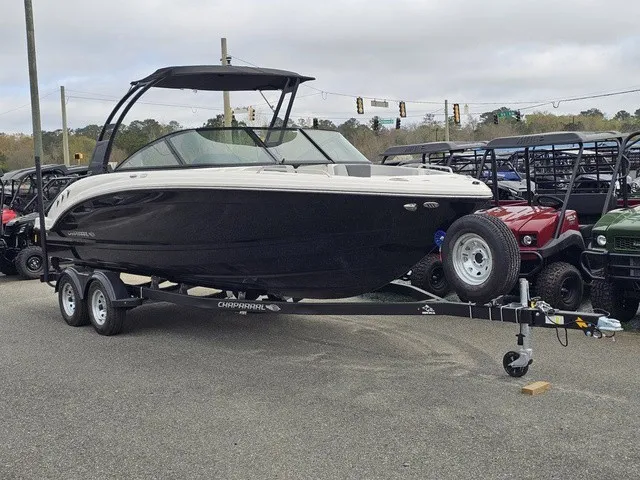 Slide: The Image of A black Chaparral 23 SSi boat from 2026 is on a trailer in a parking lot. - 2