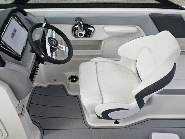 Slide: The Image of The image shows the cockpit of a Chaparral 23 SSi boat with a white seat and modern steering. - 35