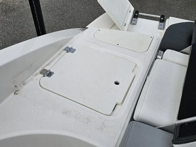Slide: The Image of The image shows the rear deck of a Chaparral 23 SSi boat with storage hatches. - 16