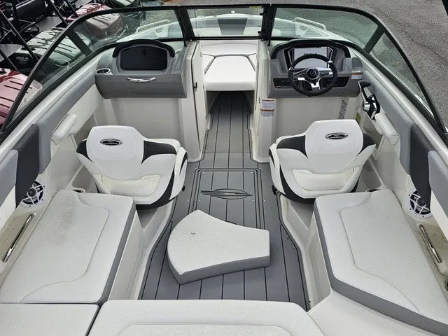 Slide: The Image of The image shows the cockpit of a Chaparral 23 SSi boat with modern seating and controls. - 12