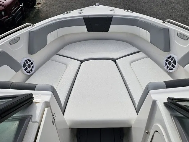 Slide: The Image of The image shows the bow area of a Chaparral 23 SSi boat with cushioned seating and speakers. - 27