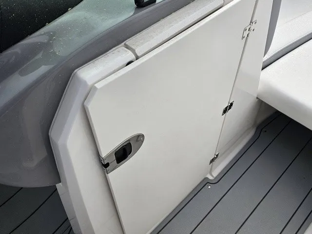 Slide: The Image of A white door with a handle on a boat, surrounded by gray flooring. - 32