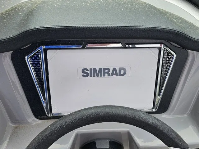 Slide: The Image of The image shows a Simrad display on a boat, surrounded by a sleek dashboard. - 24