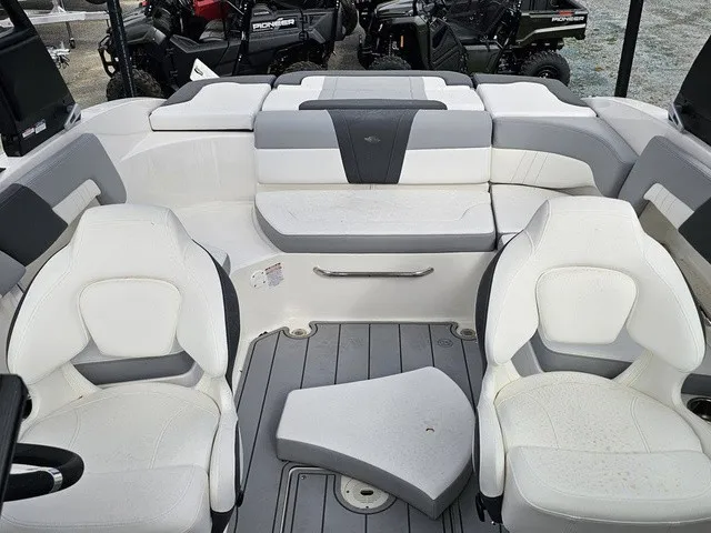 Slide: The Image of The image shows the cockpit of a Chaparral 23 SSi boat with white and gray seating. - 31
