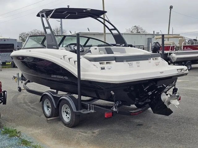Slide: The Image of A 2026 Chaparral 23 SSi boat on a trailer, featuring a black hull and white deck. - 8