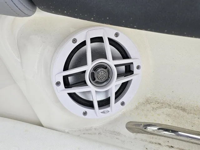 Slide: The Image of A speaker is embedded in the white interior paneling of a boat. - 19