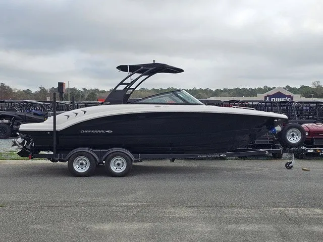 Slide: The Image of A 2026 Chaparral 23 SSi boat is on a trailer in a parking lot. - 5