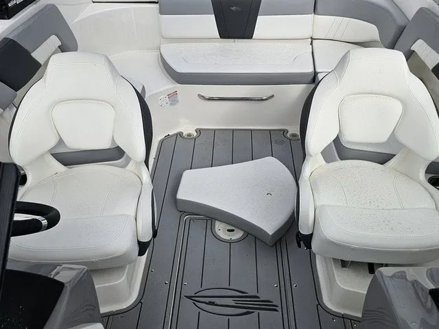 Slide: The Image of Interior of a Chaparral 23 SSi boat with white seating and gray flooring. - 30