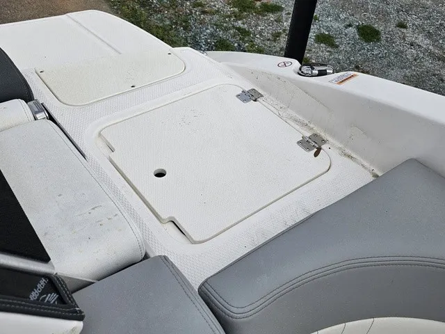 Slide: The Image of The image shows the stern of a Chaparral 23 SSi boat with gray upholstery and a white hatch. - 18