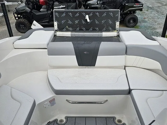 Slide: The Image of The image shows the seating area of a 2026 Chaparral 23 SSi boat with gray and white upholstery. - 13