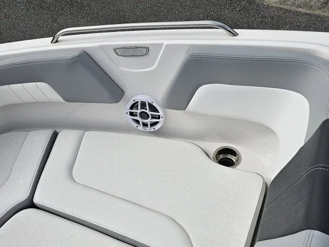 Slide: The Image of The image shows the bow area of a Chaparral 23 SSi boat with white and gray upholstery. - 29