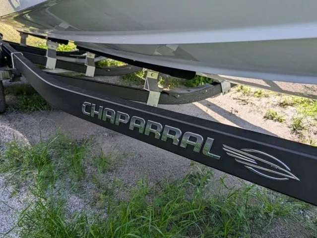 Slide: The Image of A Chaparral 23 SSi boat on a trailer, surrounded by grass and gravel. - 6
