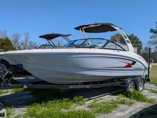 Slide: The Image of A modern 2026 Chaparral 23 SSi on a trailer. It features sleek design and dual bimini tops. - 2