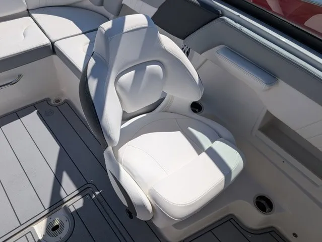 Slide: The Image of A sleek, white captain's chair on a Chaparral 23 SSi boat, surrounded by gray flooring. - 26